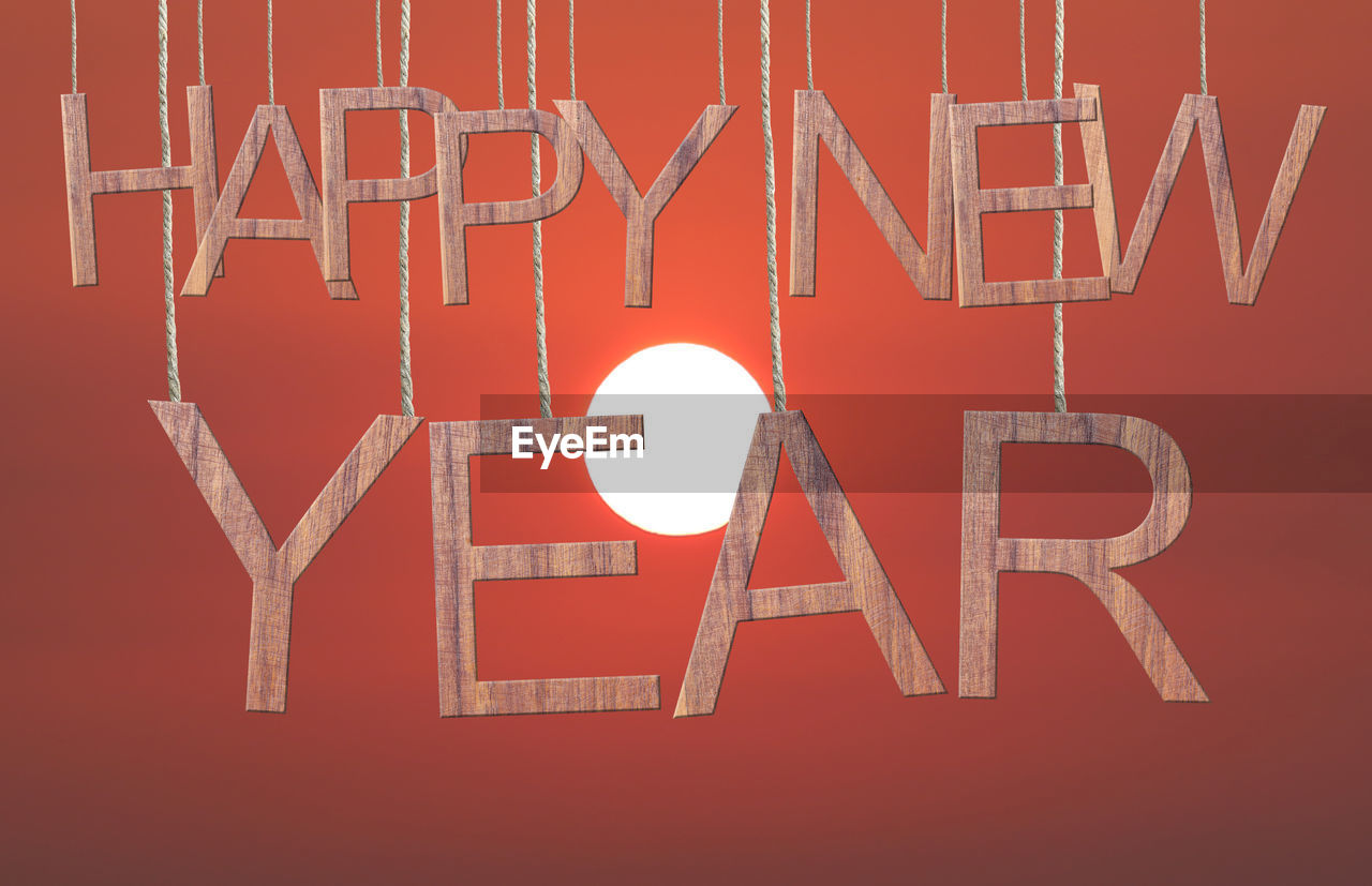 Close-up of happy new year text against red background