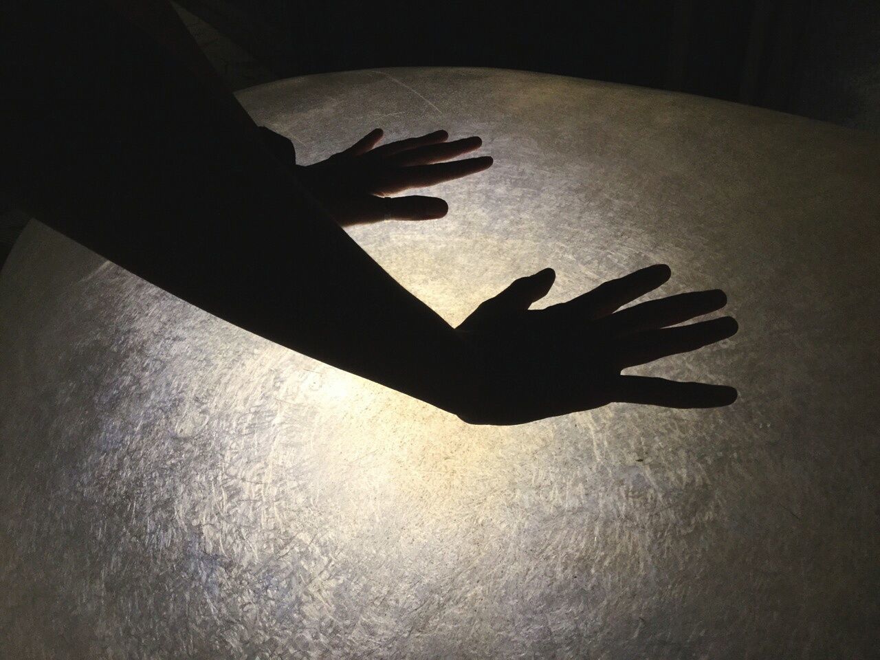 Silhouette hands touching glass