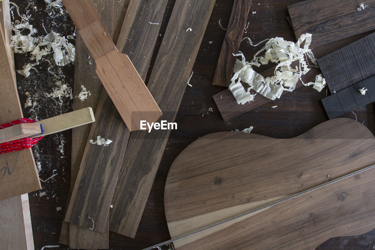 High angle view of wooden planks on table at carpentry workshop