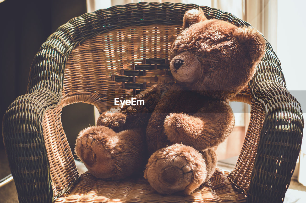 Stuffed teddy bear on chair at home