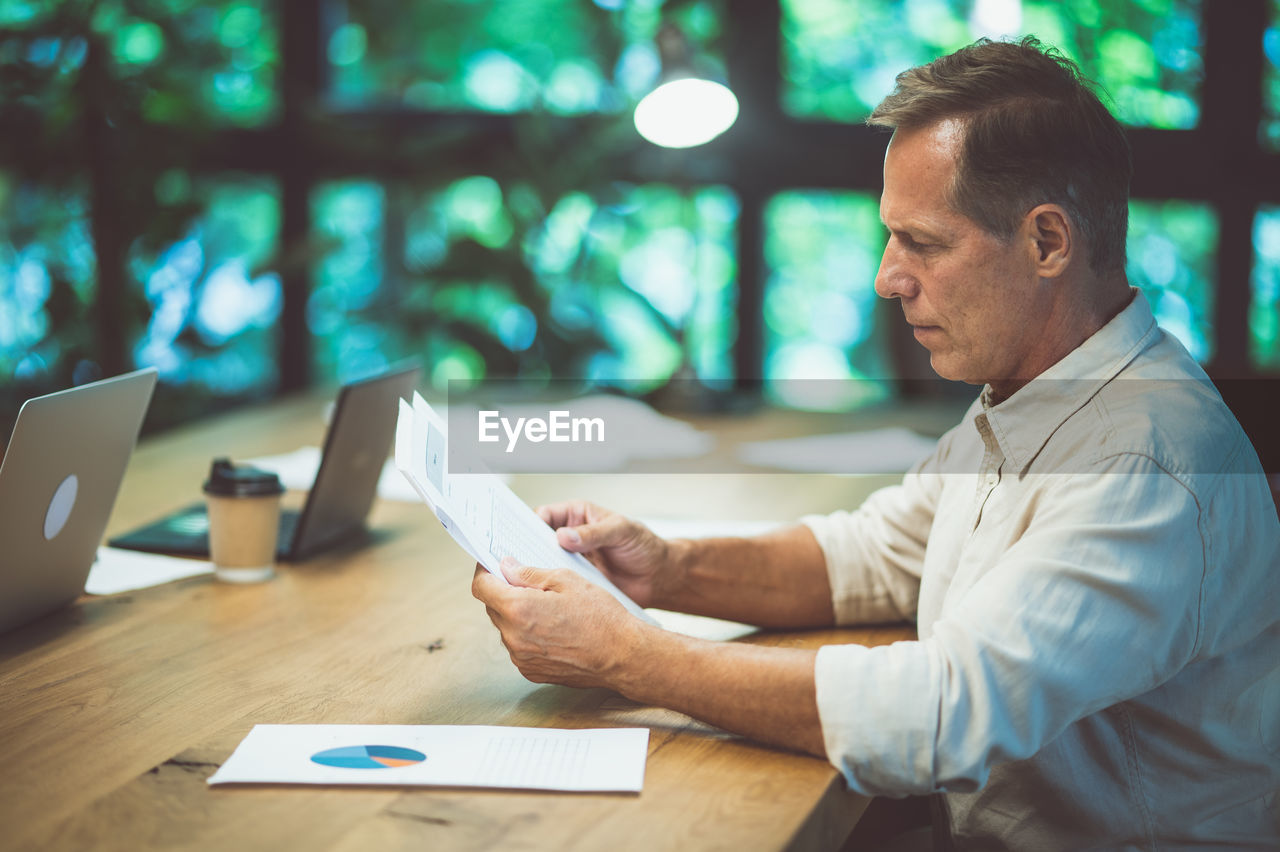 midsection of businessman working at desk in office