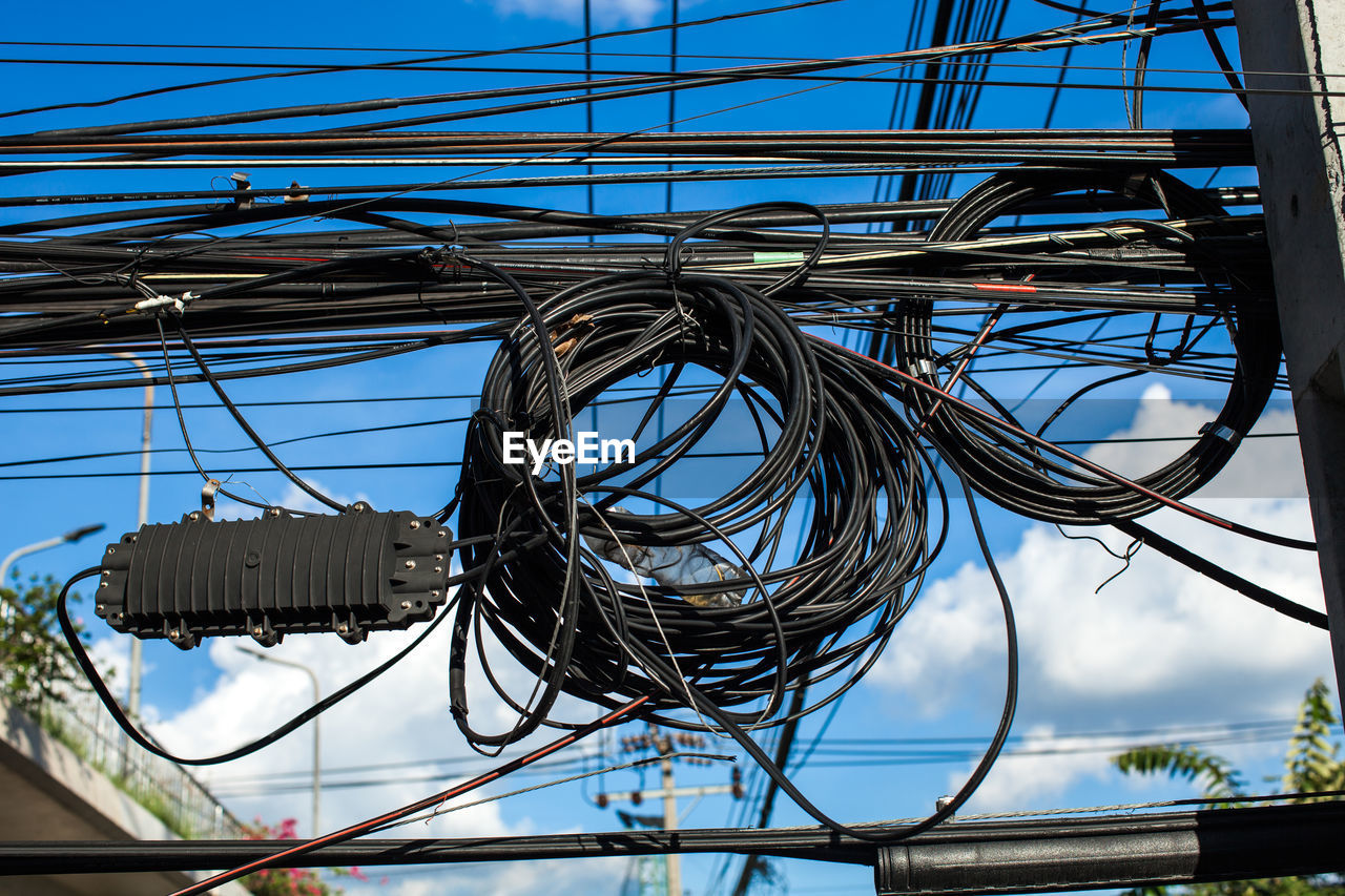 CLOSE-UP LOW ANGLE VIEW OF CABLES AGAINST SKY