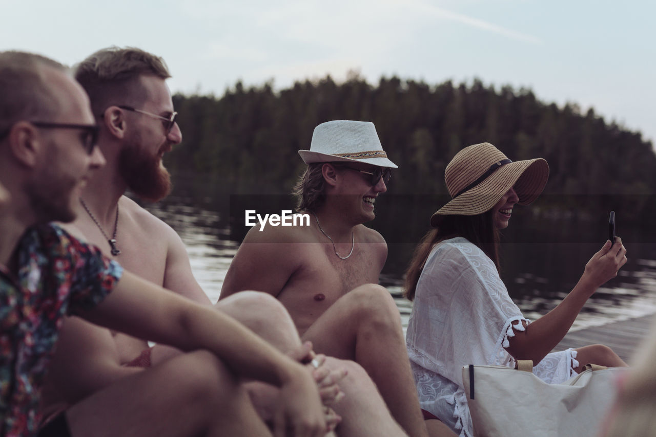 Friends relaxing at lake