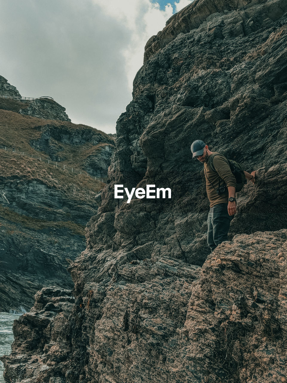 Low angle view of man standing on rock formation