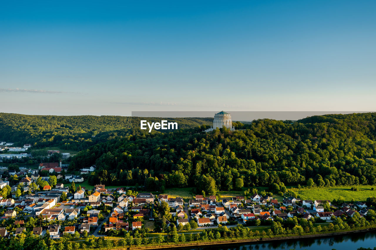 High angle view of buildings and trees in town