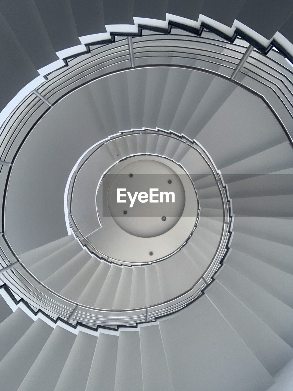 spiral, staircase, spiral staircase, steps and staircases, railing, architecture, wheel, circle, stairs, indoors, built structure, spoke, hubcap, aircraft engine, no people, ceiling, directly above, pattern, diminishing perspective, geometric shape, shape, daylighting, directly below, bicycle wheel, high angle view, curve