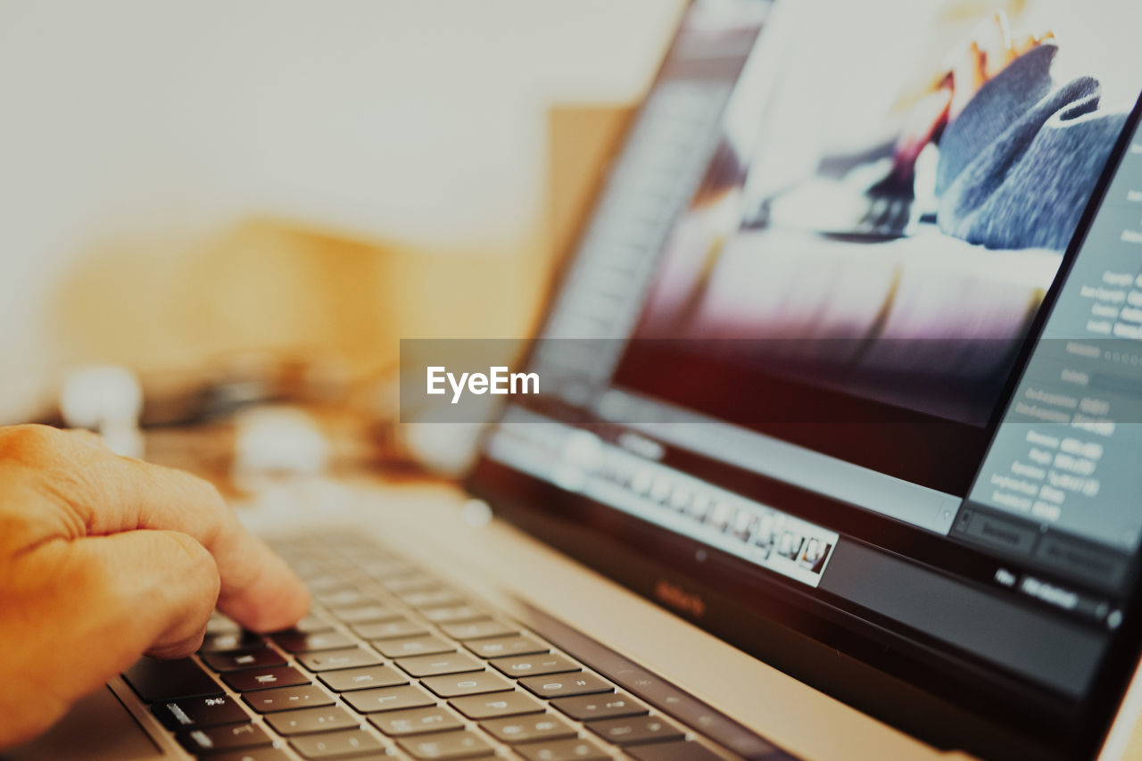 Close-up of man using laptop 