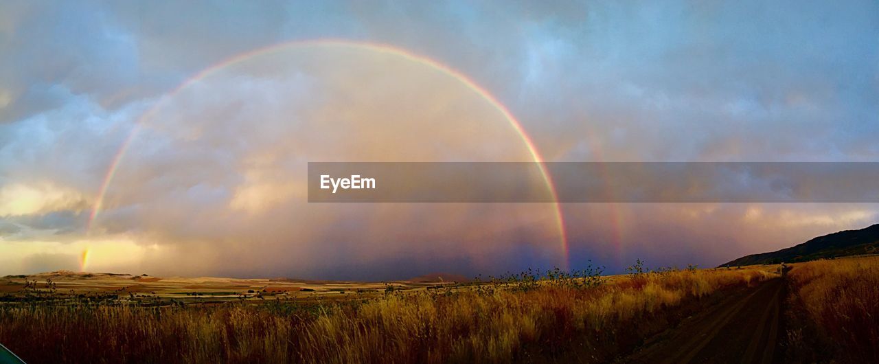 SCENIC VIEW OF MOUNTAINS AGAINST CLOUDY SKY