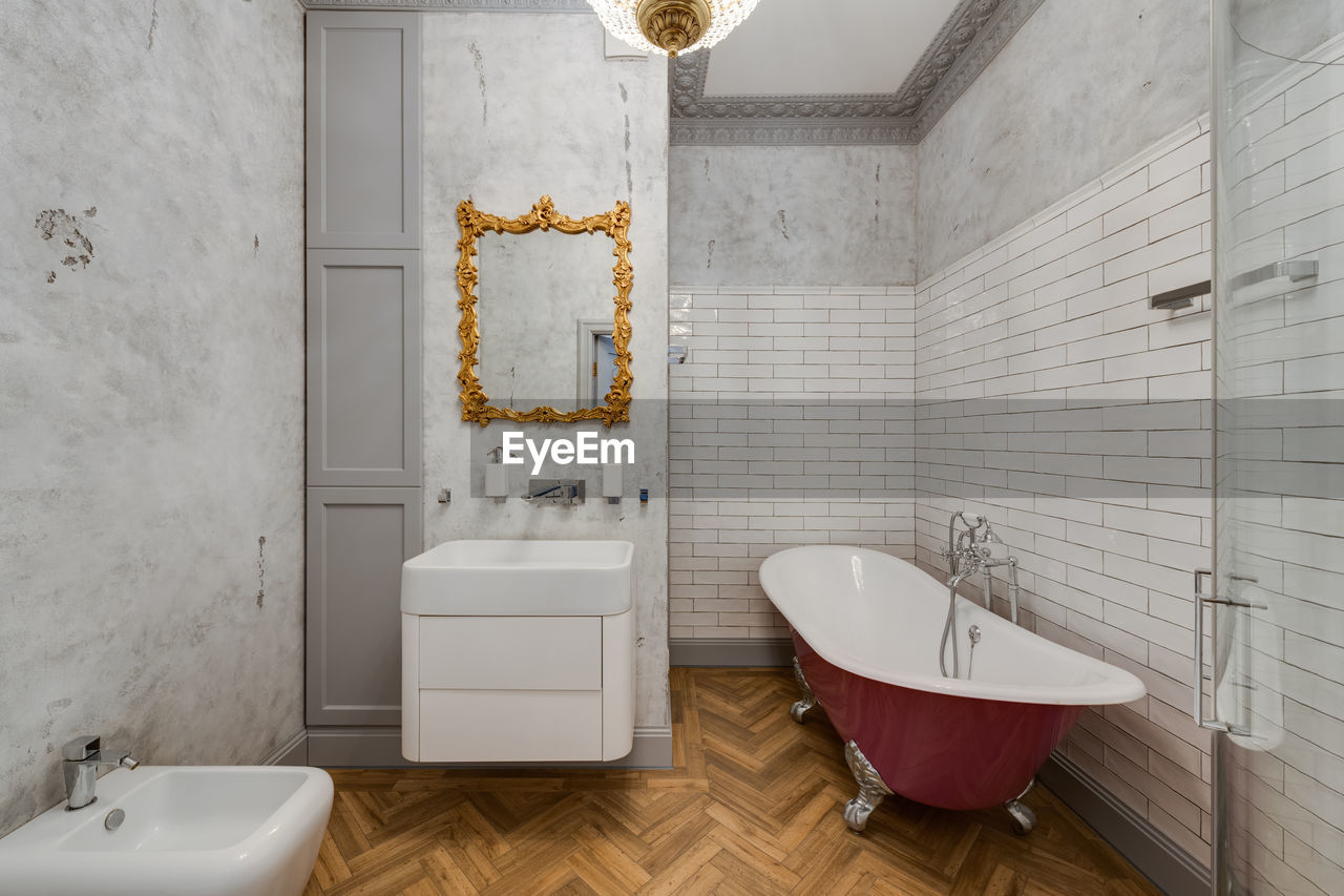 Grey bathroom with classic-style pink bathtub