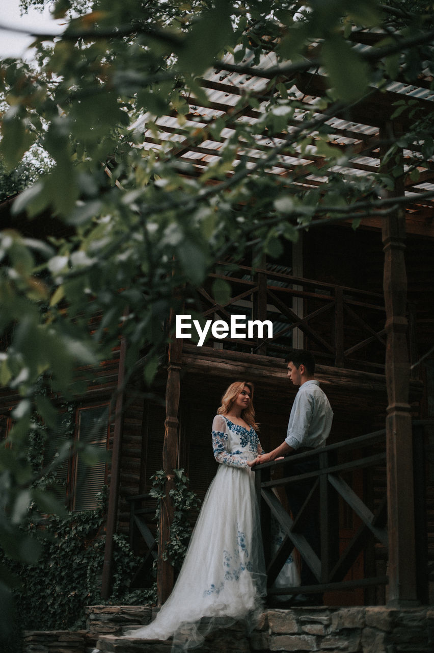 Couple standing at cottage