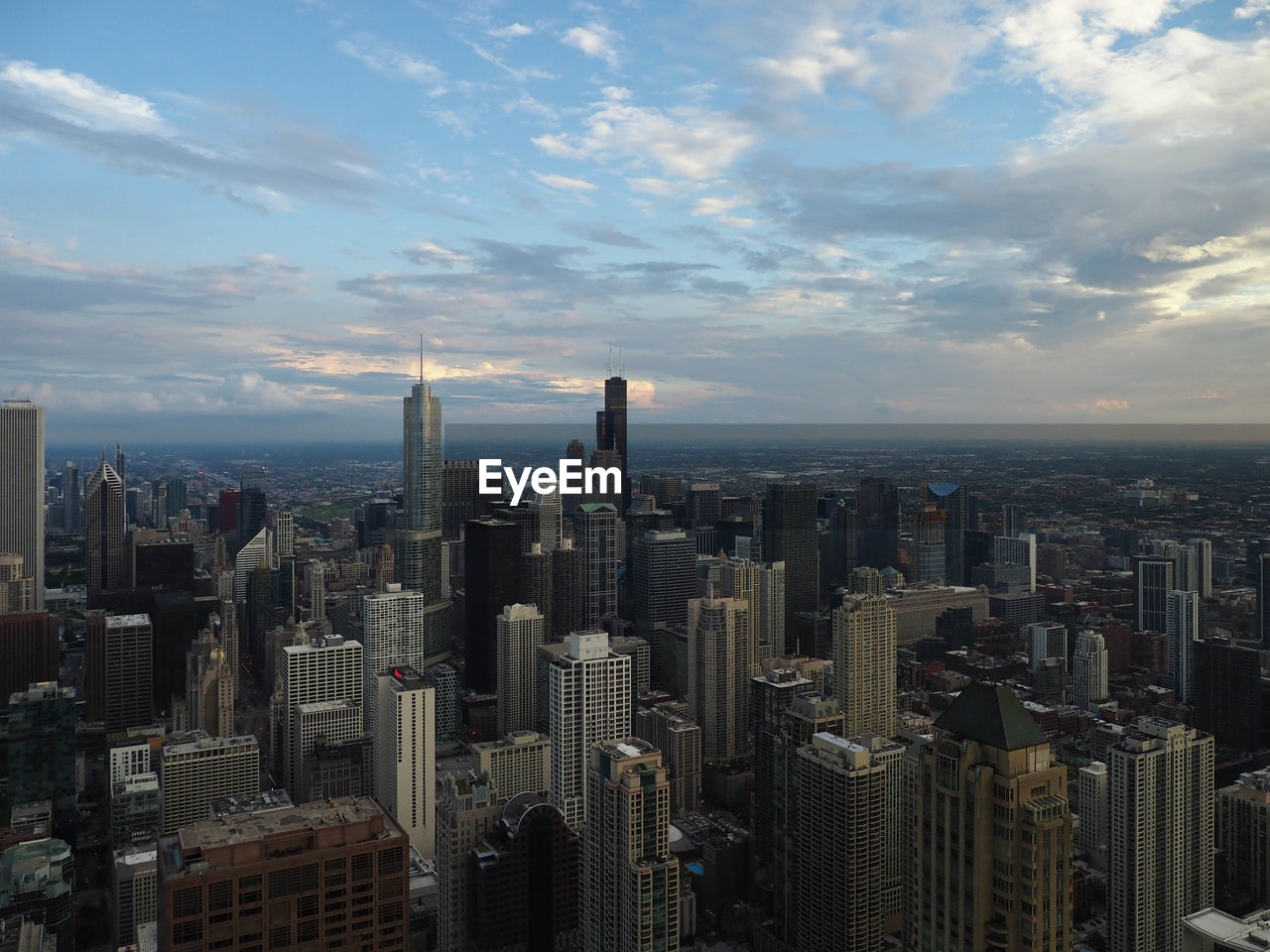 Aerial view of modern buildings in city against sky