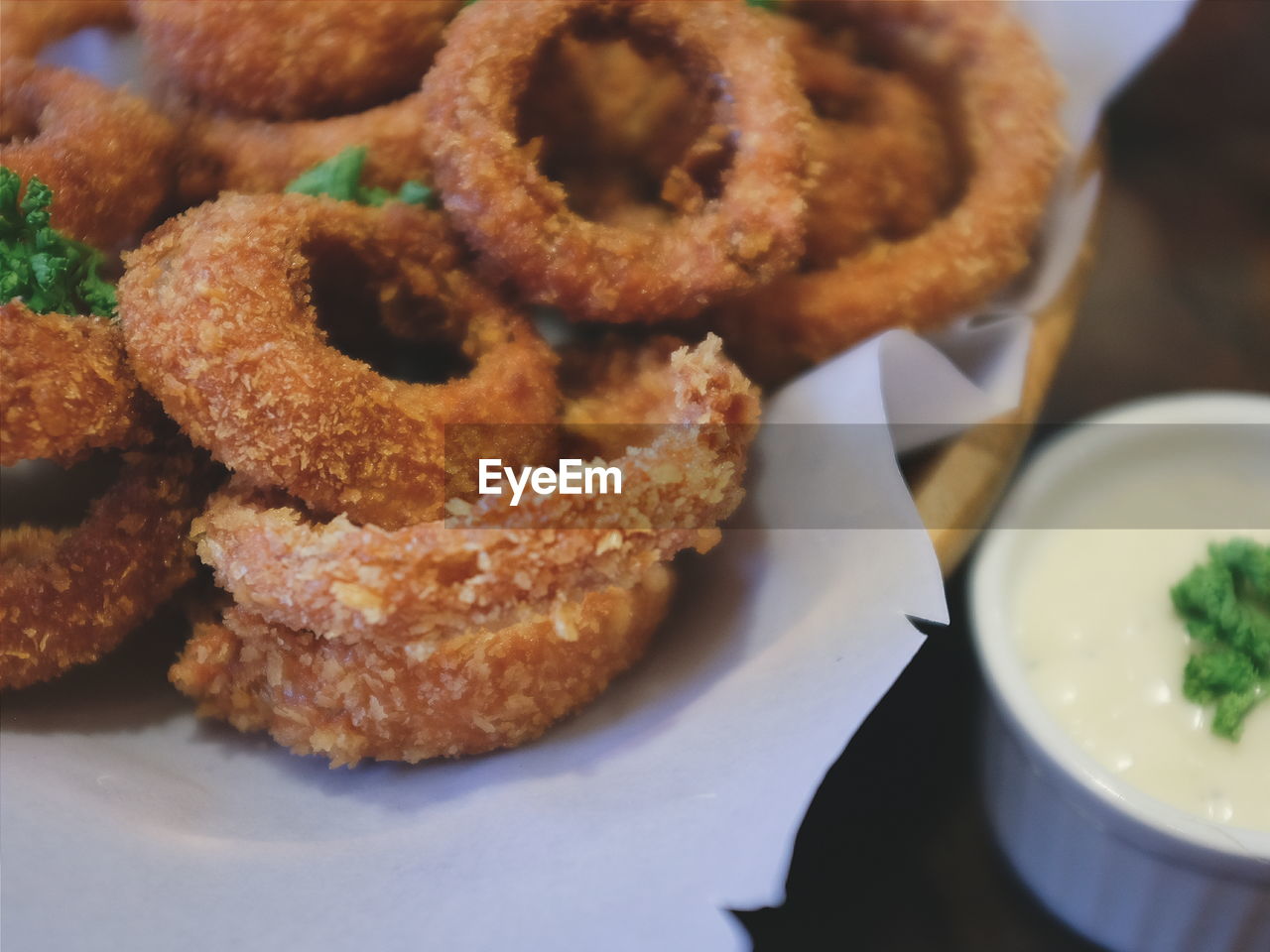 Close-up of onion rings in plate with sauce