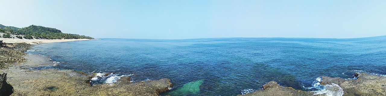 SCENIC VIEW OF SEA WITH MOUNTAIN IN BACKGROUND