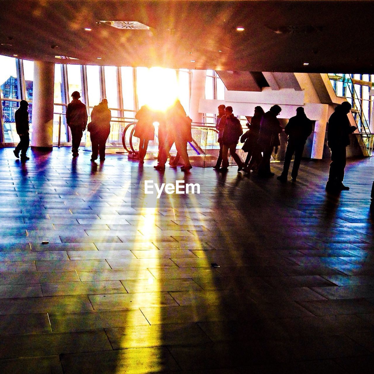 Silhouette people on flooring in building