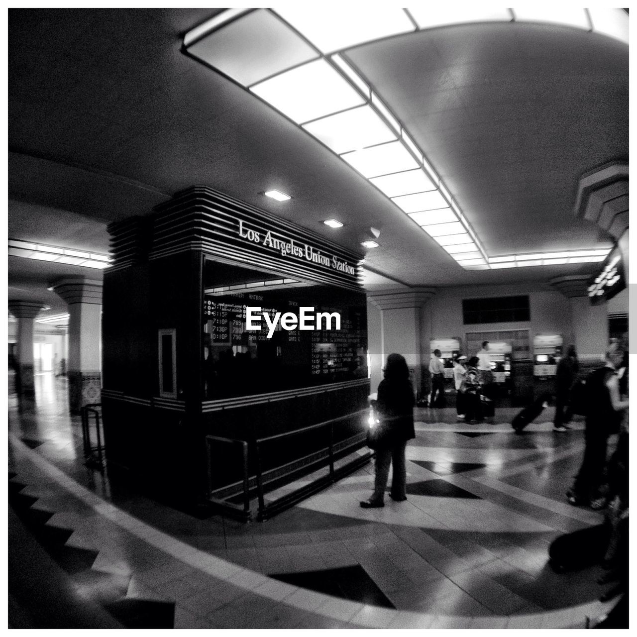 Rear view of woman looking at arrival departure board