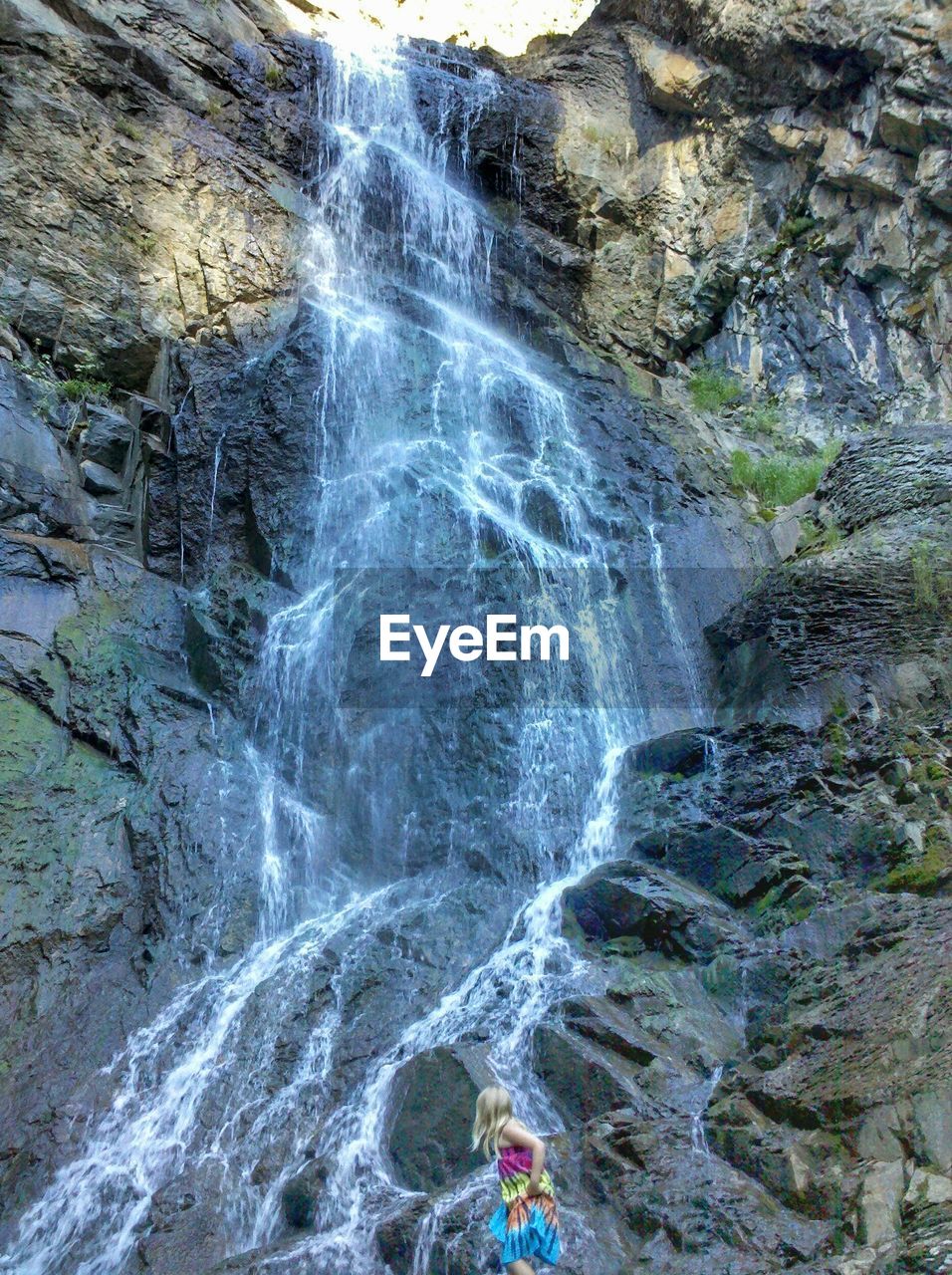 VIEW OF WATERFALL WITH ROCKS IN WATER
