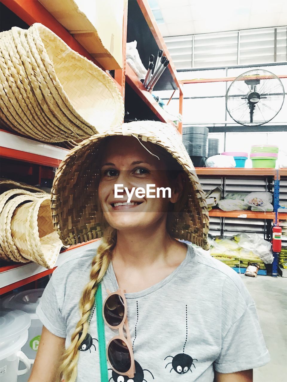 Portrait of smiling woman wearing hat in store