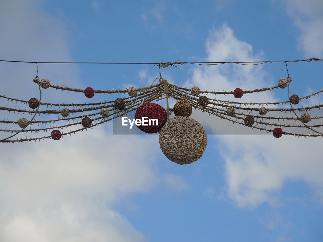 Low angle view of christmas street decoration hanging against sky