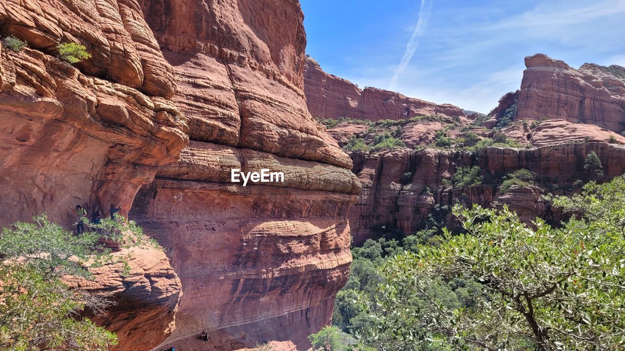 rock, canyon, rock formation, nature, travel destinations, scenics - nature, environment, travel, beauty in nature, landscape, land, non-urban scene, sky, arch, wadi, plant, no people, national park, geology, valley, mountain, cliff, outdoors, tranquility, tourism, terrain, tree, day, park, tranquil scene, sandstone, desert, formation, eroded, sunlight, semi-arid, escarpment, physical geography, architecture, mountain range, extreme terrain, sunny