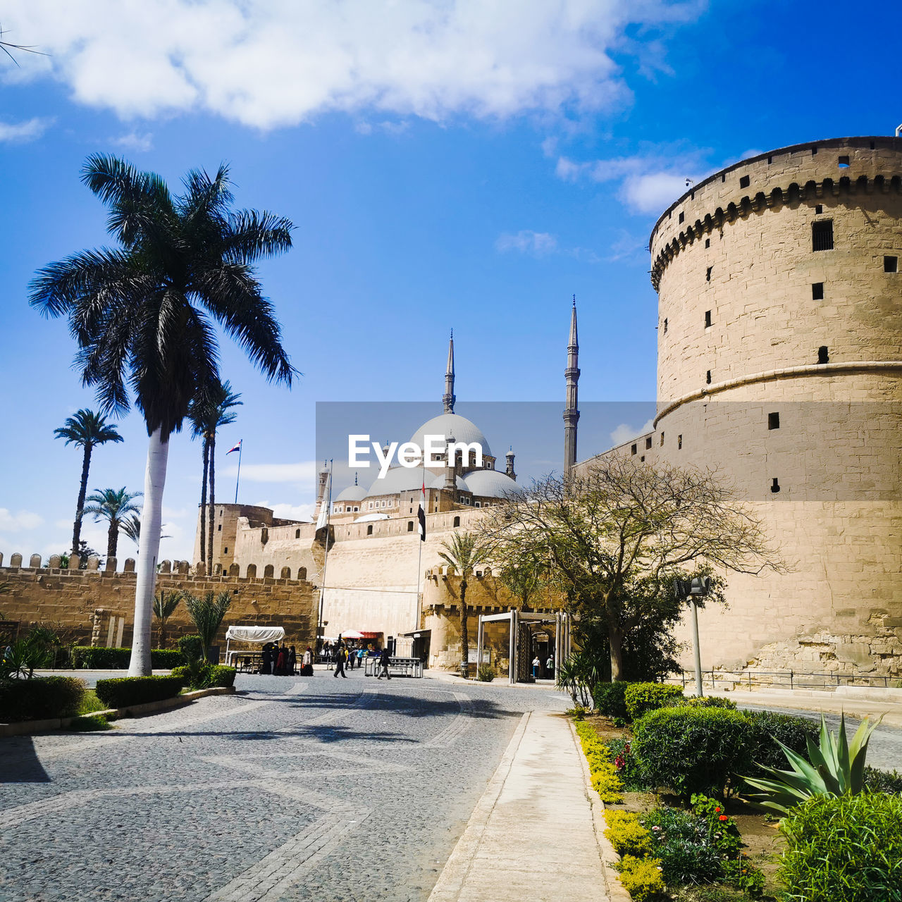 architecture, building exterior, built structure, sky, nature, tree, travel destinations, plant, palm tree, building, city, travel, cloud, tropical climate, history, the past, street, tower, outdoors, tourism, no people, blue, day, religion, dome, road, industry, footpath, sunlight