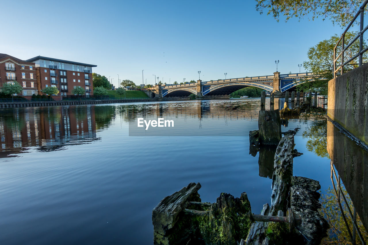 ARCH BRIDGE OVER RIVER AGAINST CLEAR SKY