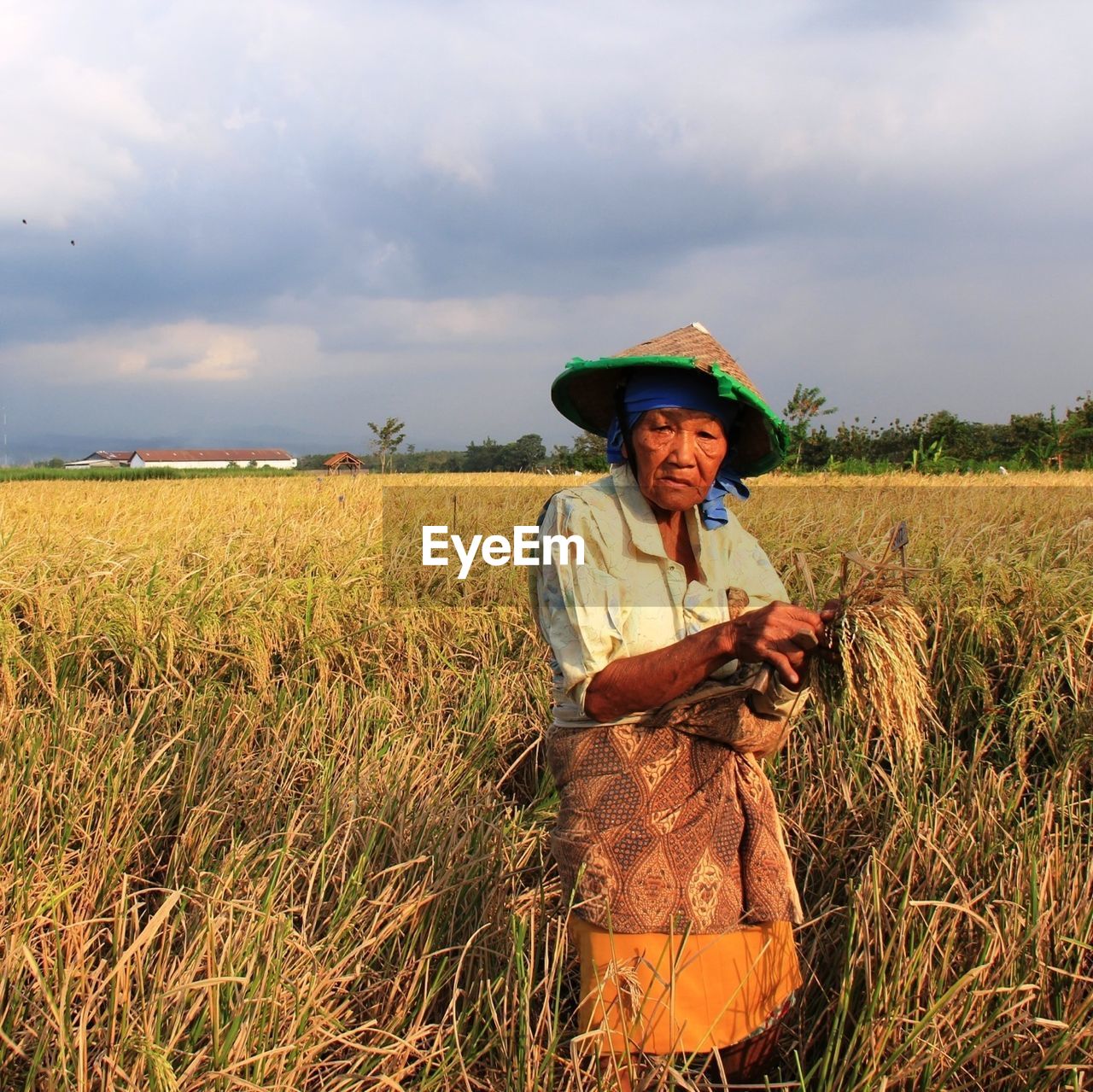 WOMAN STANDING ON GRASSY FIELD