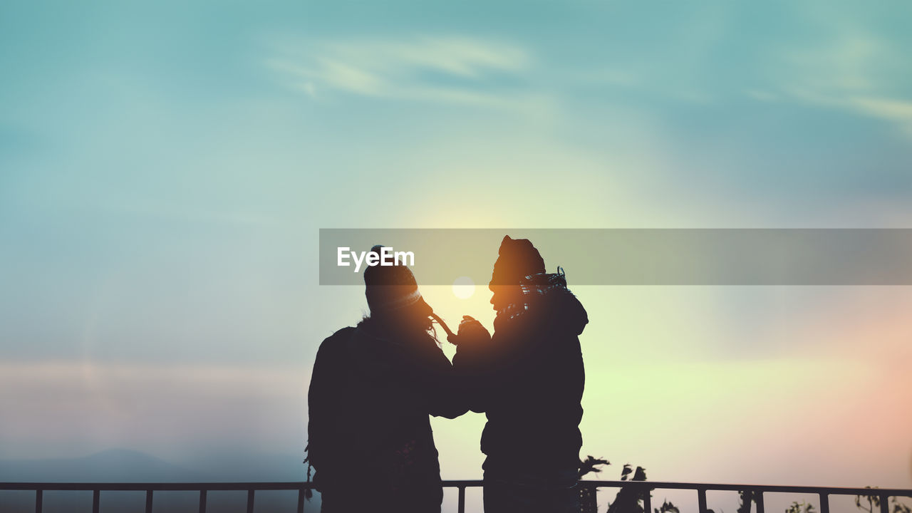 low angle view of silhouette man standing against sky during sunset