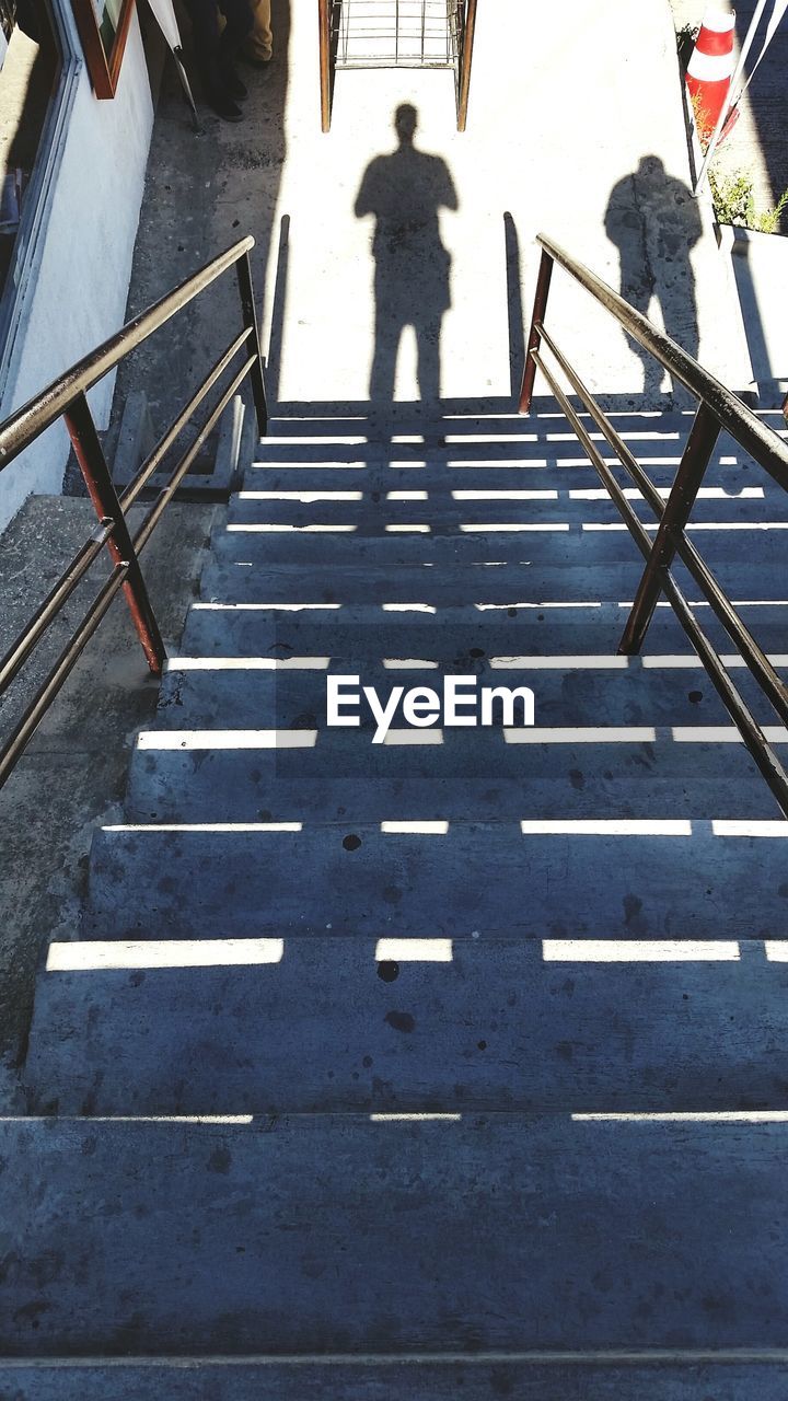 High angle view of people walking on staircase