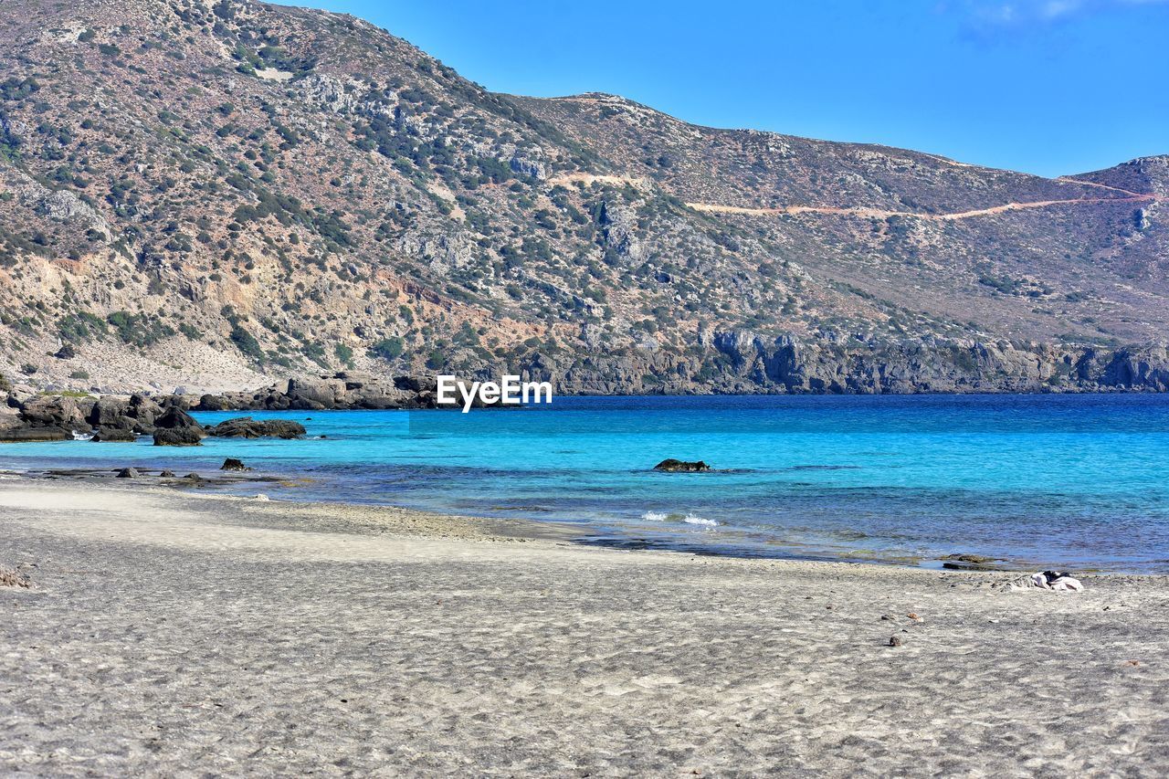 Scenic view of sea against clear blue sky