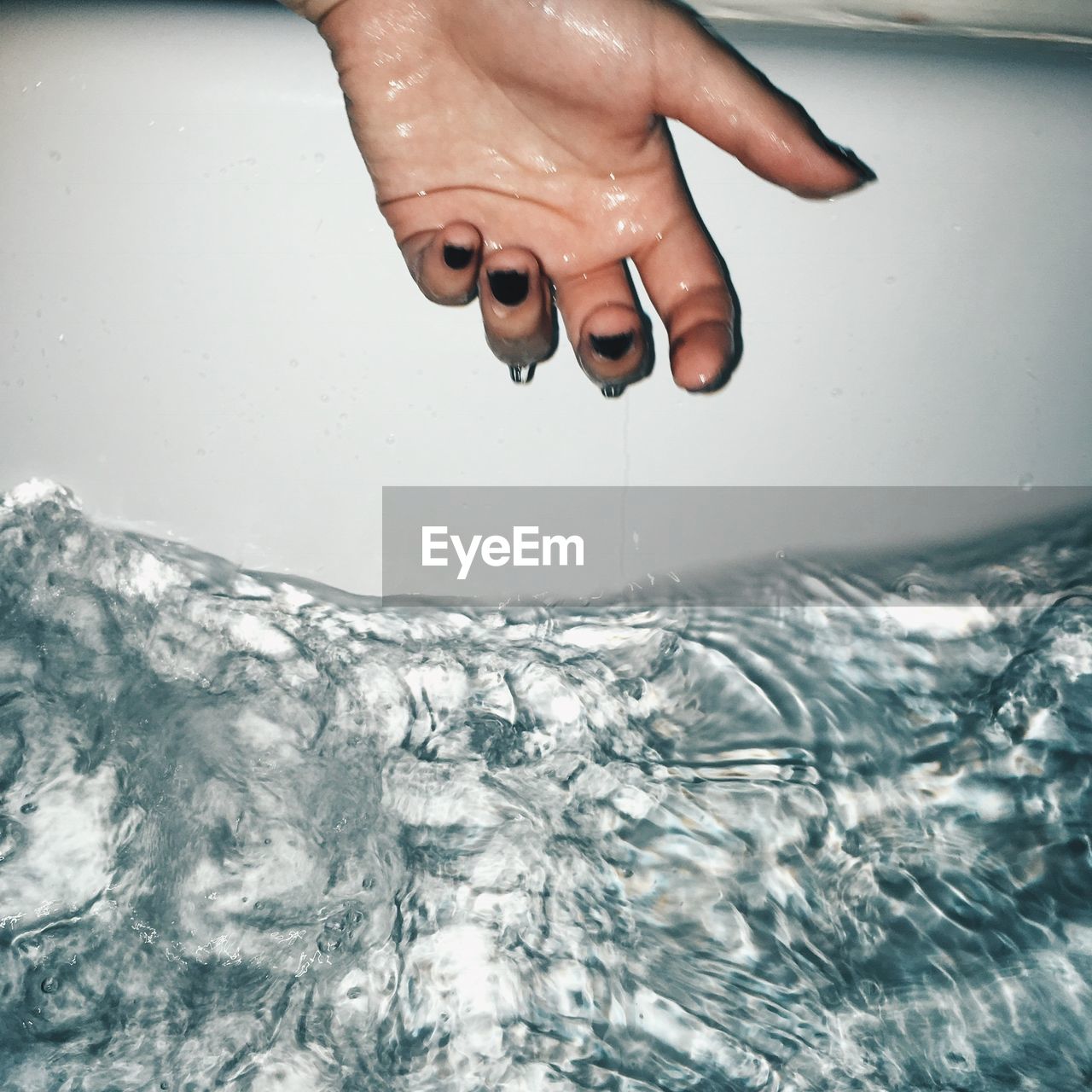 Cropped image of woman washing hand in water