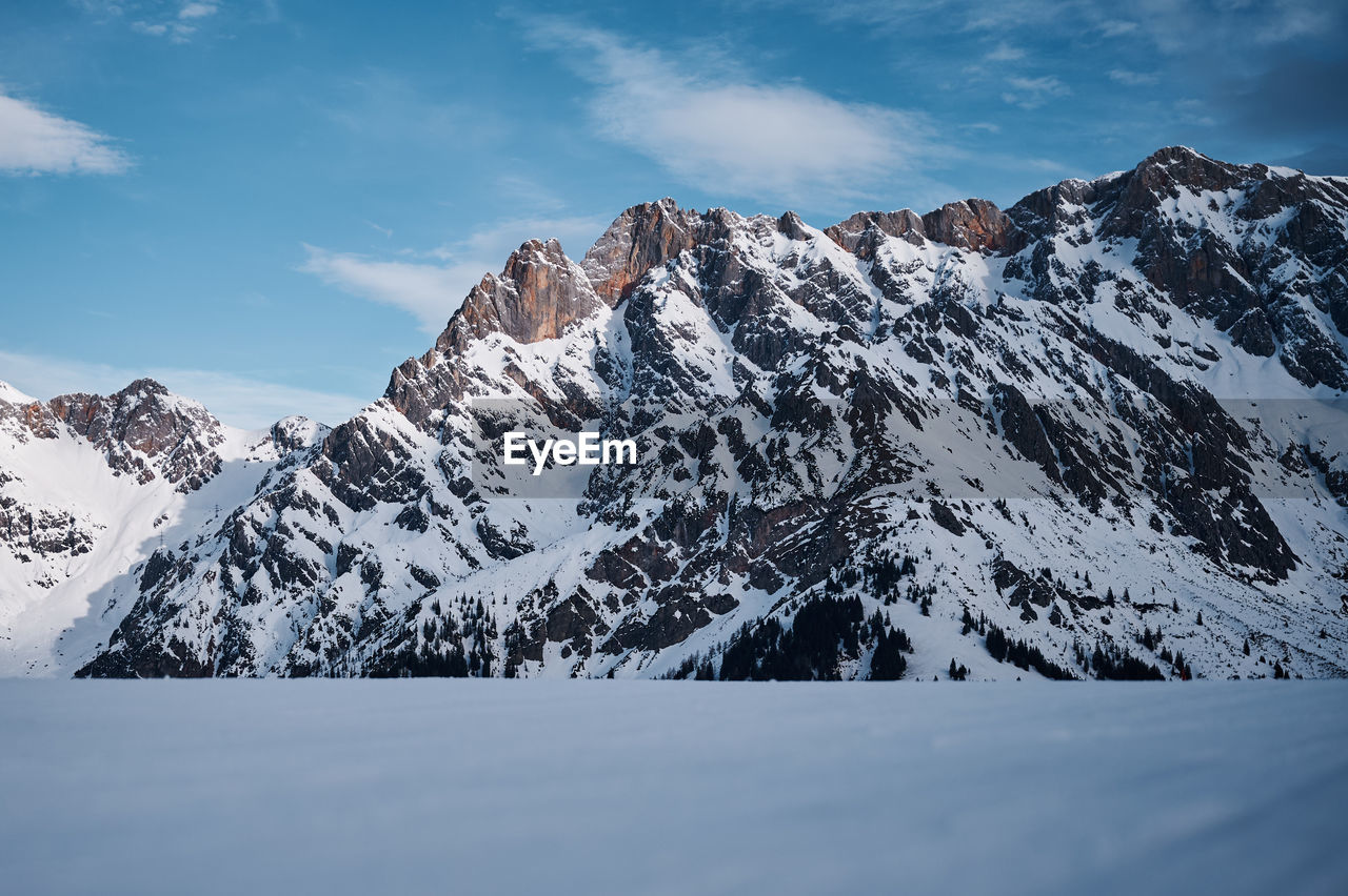 low angle view of snowcapped mountains against sky