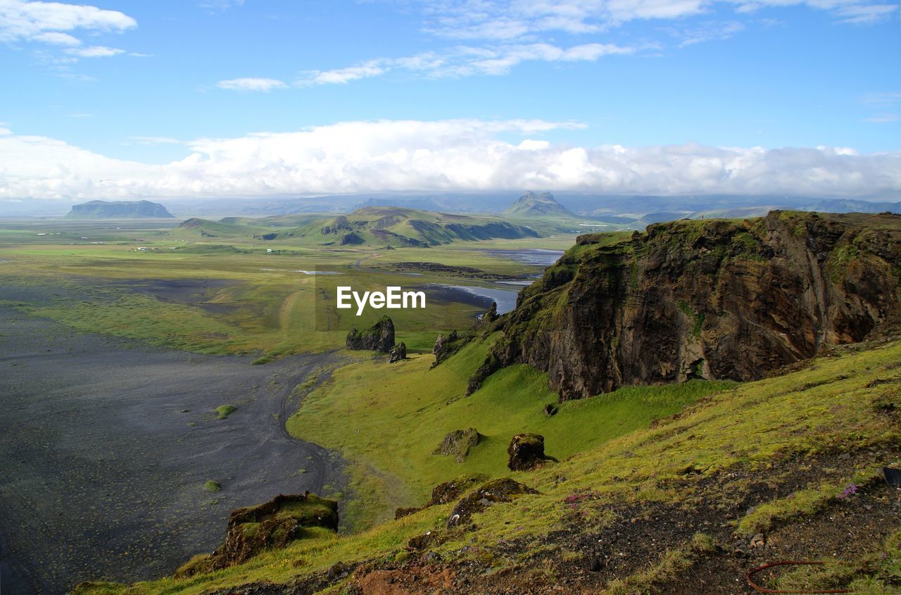 Scenic view of green landscape against sky