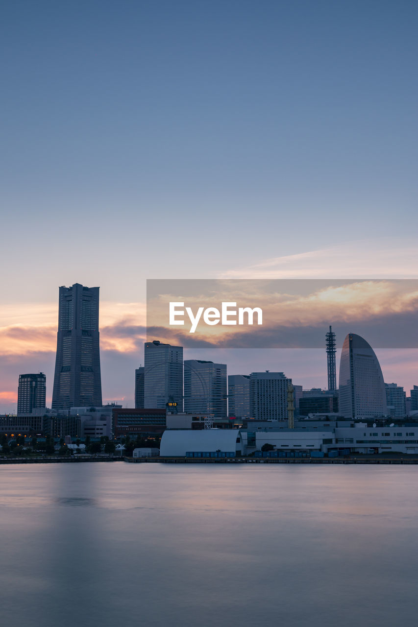 Minato mirai skyline during the sunset with the reflection in the sea. long exposure.