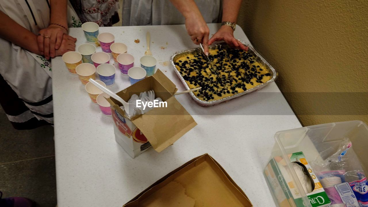 HIGH ANGLE VIEW OF WOMAN HAVING FOOD AT TABLE
