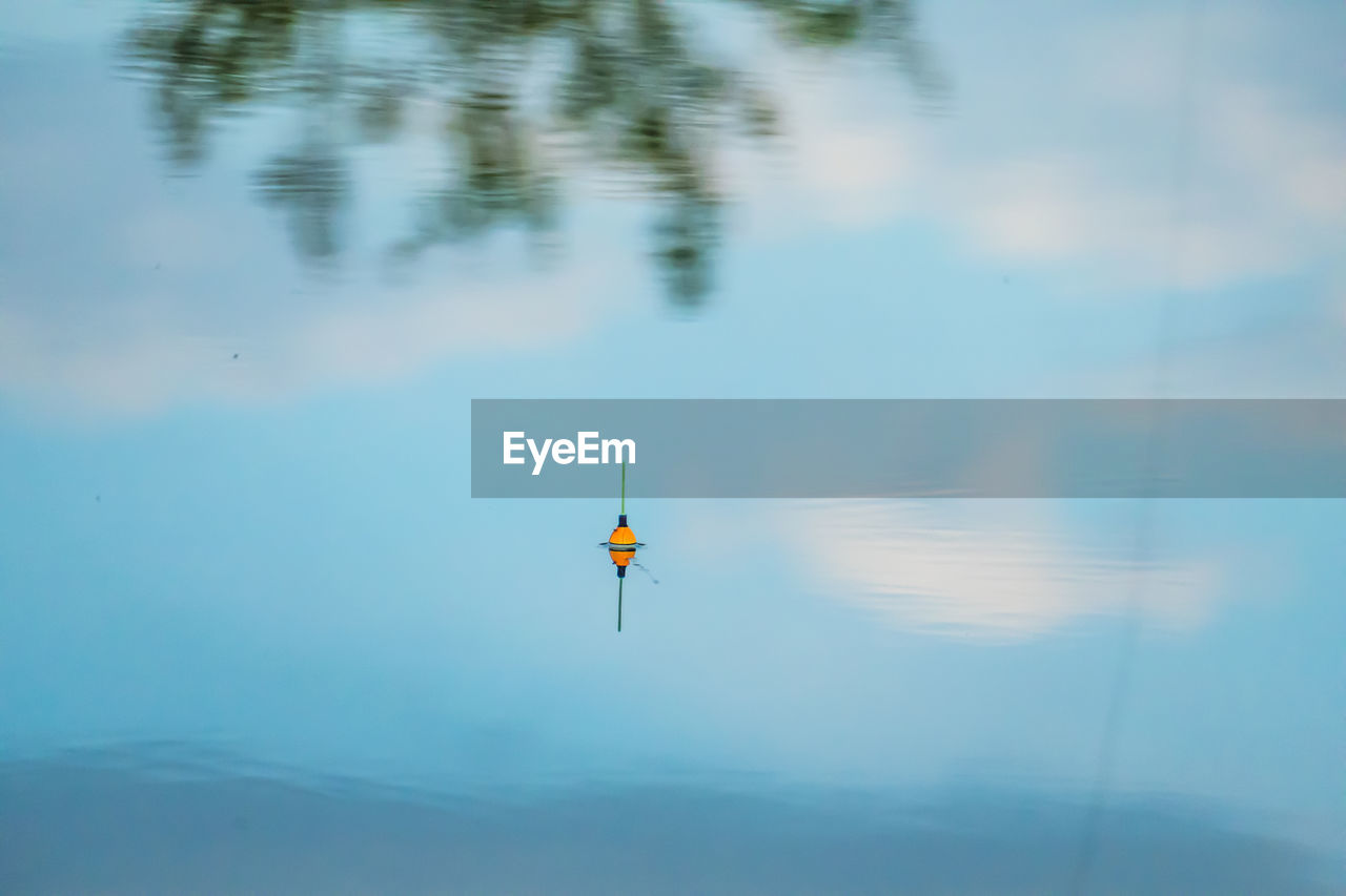 FLAG ON LAKE AGAINST SKY