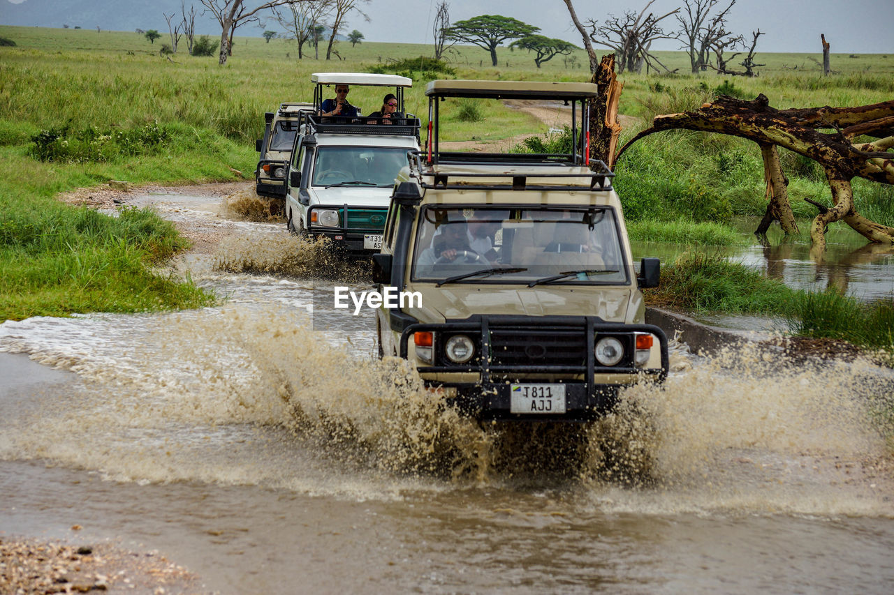 VEHICLE ON DIRT ROAD BY LAND