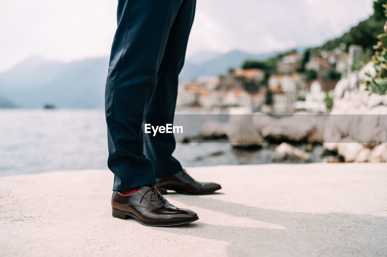 LOW SECTION OF MAN STANDING ON WATER