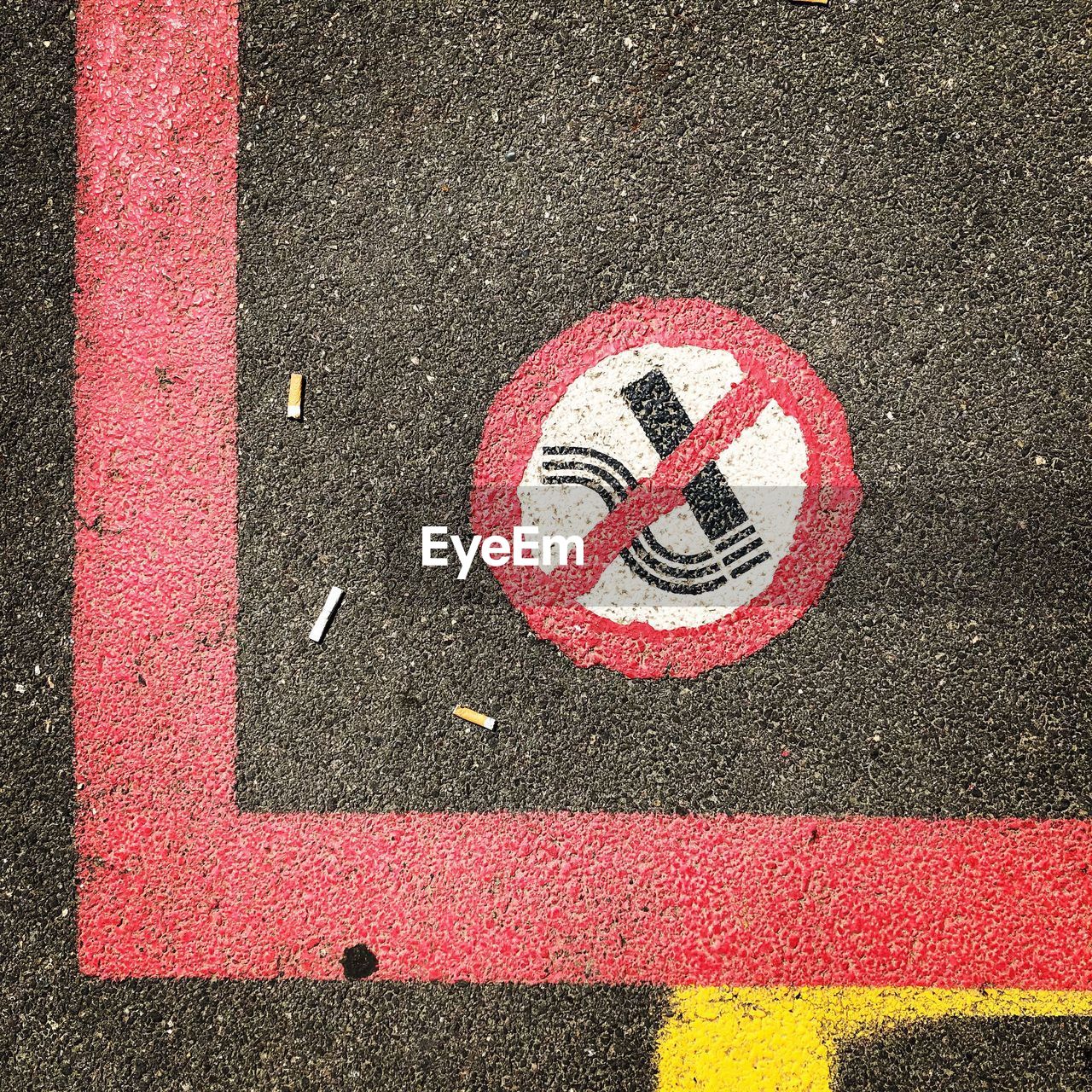 High angle view of no smoking sign on road