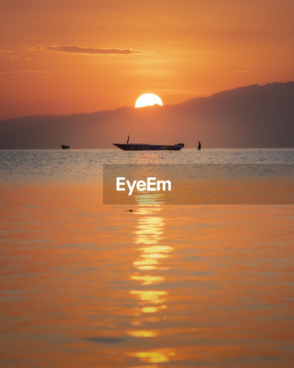 Scenic view of sea against orange sky