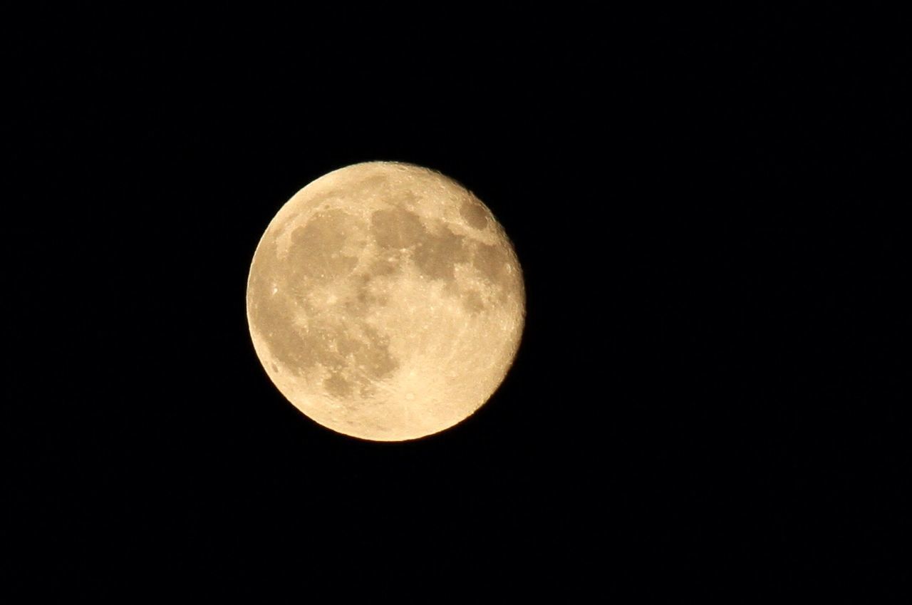 LOW ANGLE VIEW OF MOON AGAINST CLEAR SKY