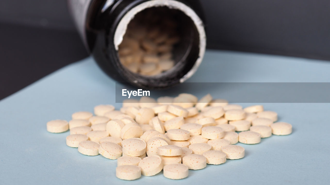 high angle view of pills in glass on table