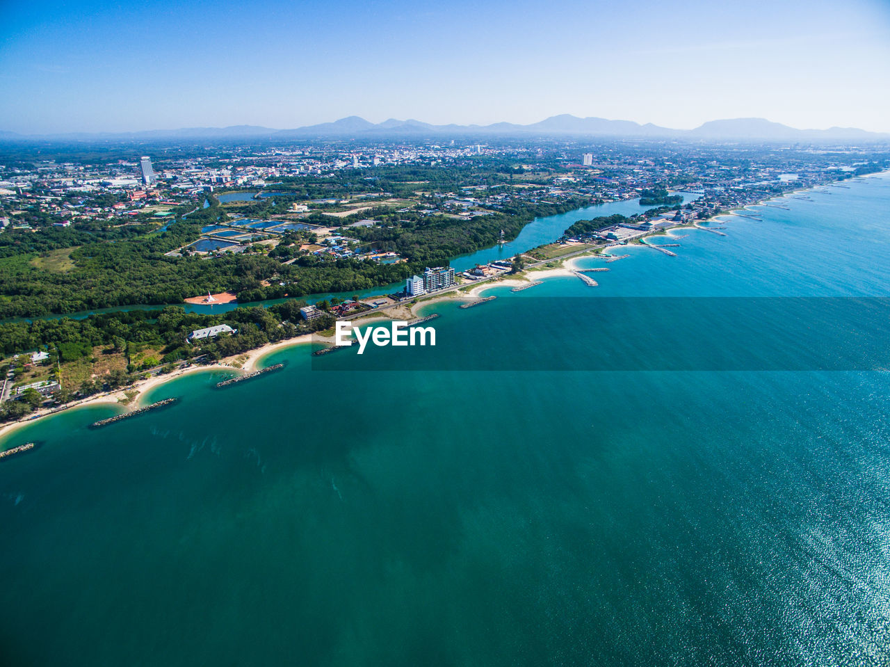 High angle view of sea and cityscape against sky