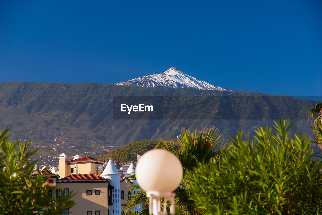 View of volcanic mountain against blue sky