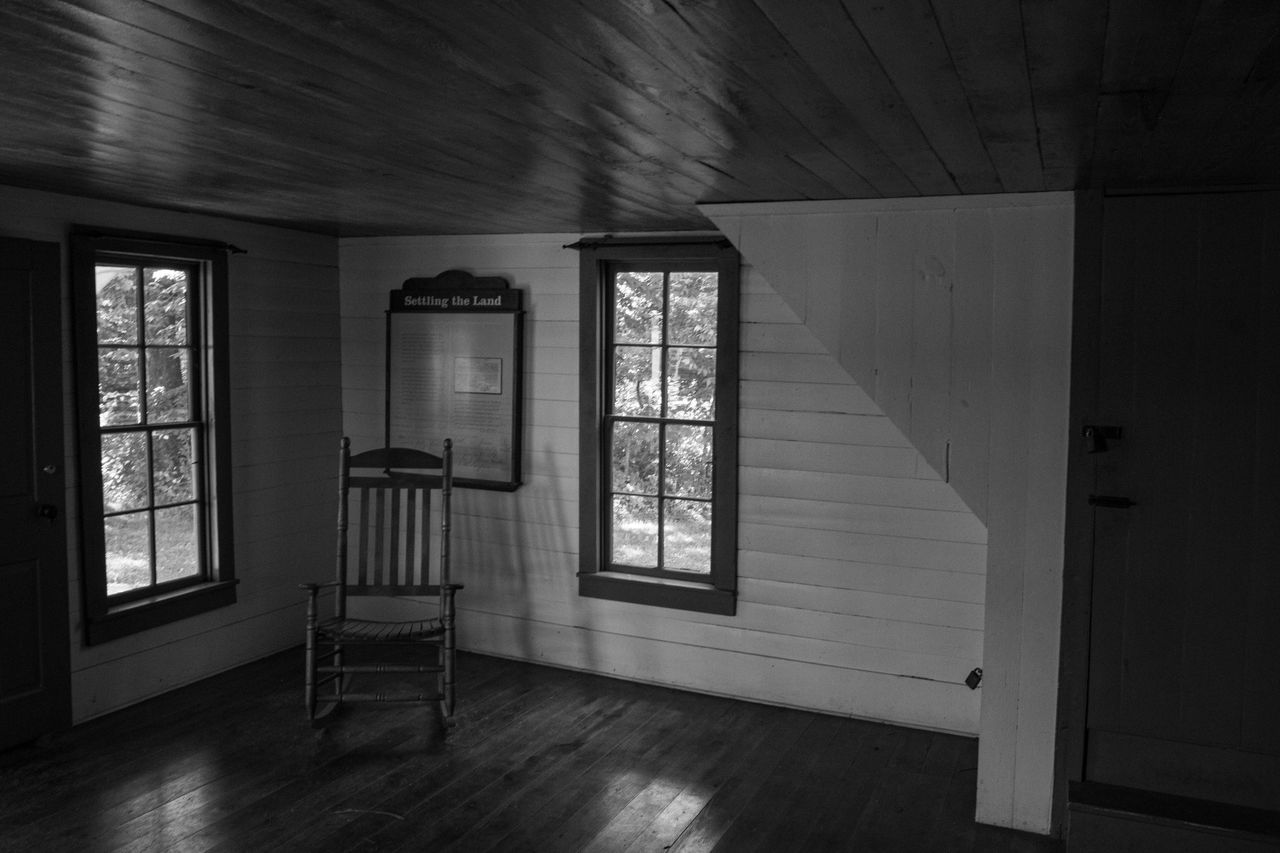 indoors, window, house, architecture, white, black, flooring, darkness, home interior, black and white, light, home, no people, hardwood floor, building, wood, monochrome, built structure, door, monochrome photography, entrance, day, room, interior design, absence, wall - building feature, domestic room, sunlight, hall, floor, seat, abandoned