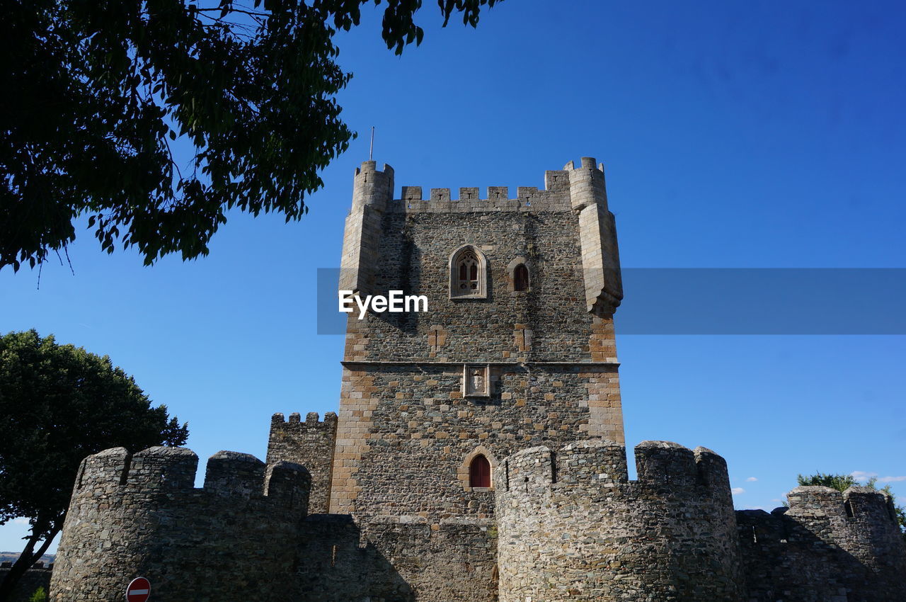 architecture, history, the past, built structure, building exterior, building, sky, castle, tree, travel destinations, nature, tower, blue, old, plant, château, medieval, clear sky, travel, fort, ancient, religion, low angle view, no people, place of worship, tourism, wall, old ruin, fortified wall, outdoors, stone material, day, sunny, belief