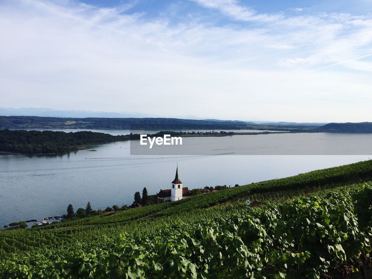 Scenic view of lake against cloudy sky