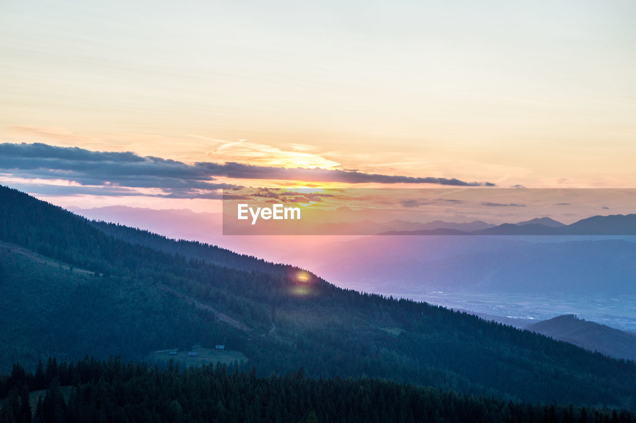 SCENIC VIEW OF MOUNTAIN AGAINST SKY DURING SUNSET