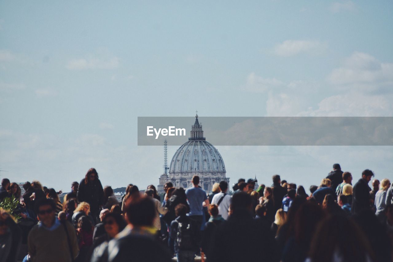 Tourist at st peters basilica against sky
