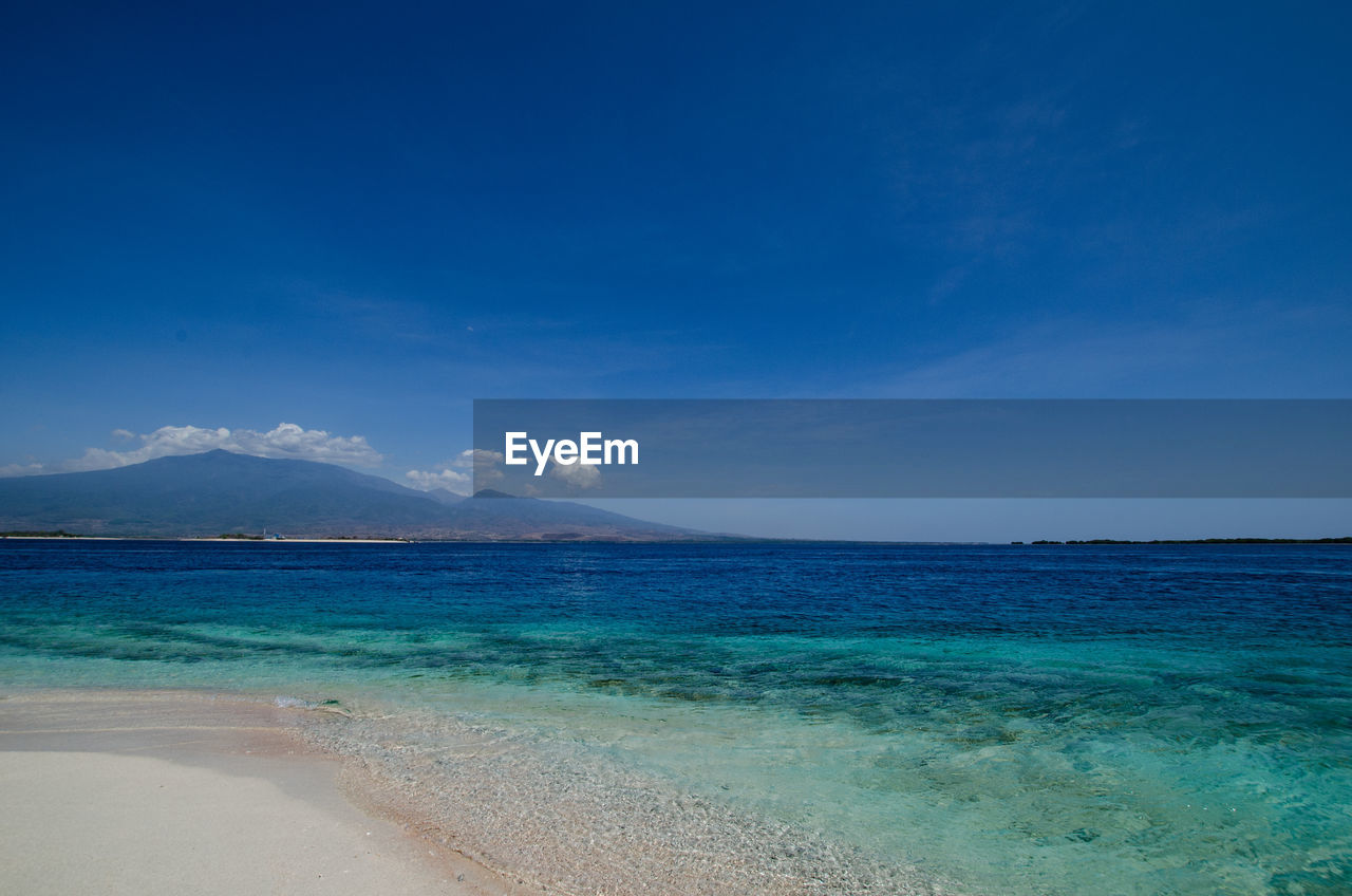Scenic view of sea against blue sky