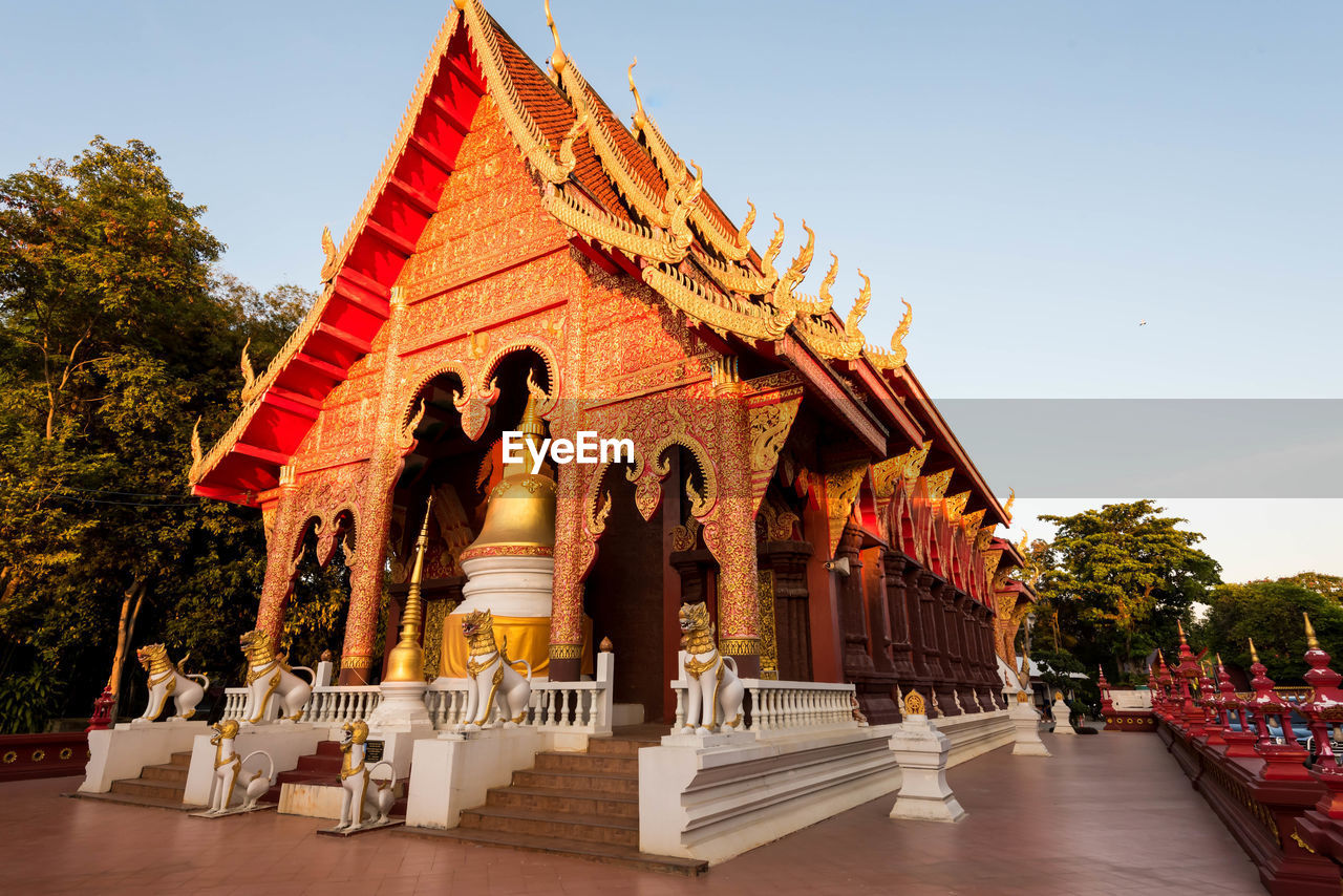 Statue of temple against building and sky in chiang rai thailand